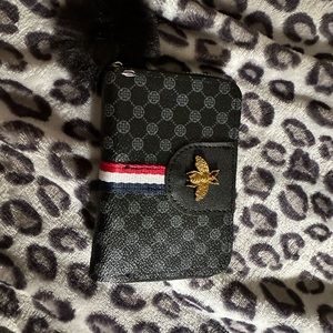 Black and gray wallet with puffy ball